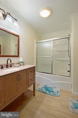 a bathroom with a double vanity sink mirror and shower