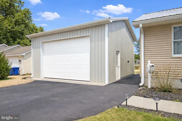 a view of a house with a backyard and garage