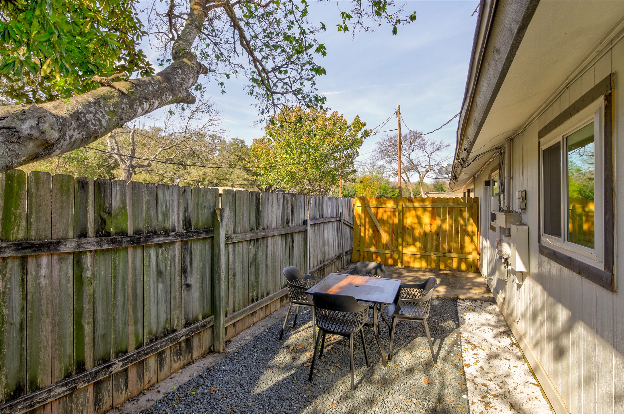 10509 Macmora Road, Unit A Austin, TX 78758 - Photo 14 of 17 A secluded patio retreat, perfect for quiet outdoor moments, bordered by a rustic wooden fence.