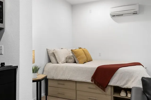 a bedroom with bed and a window