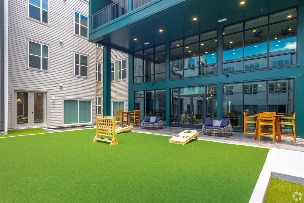 596 West 9th Street, Unit 325 Dallas, TX 75208 - Photo 9 of 25 a view of a house with a backyard patio and swimming pool