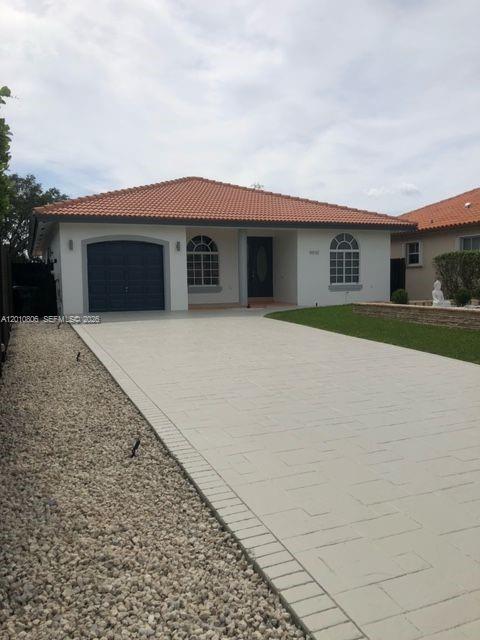 a front view of house with yard and trees
