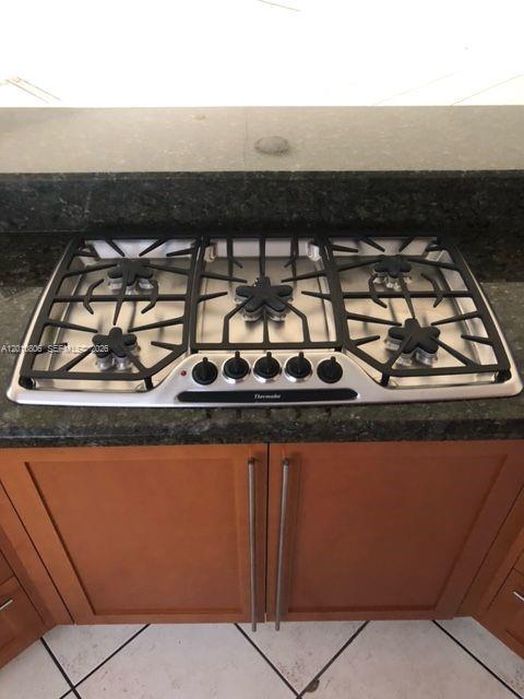 9910 Southwest 23rd Street Miami, FL 33165 - Photo 15 of 39 a close view of sink a stove and a microwave oven