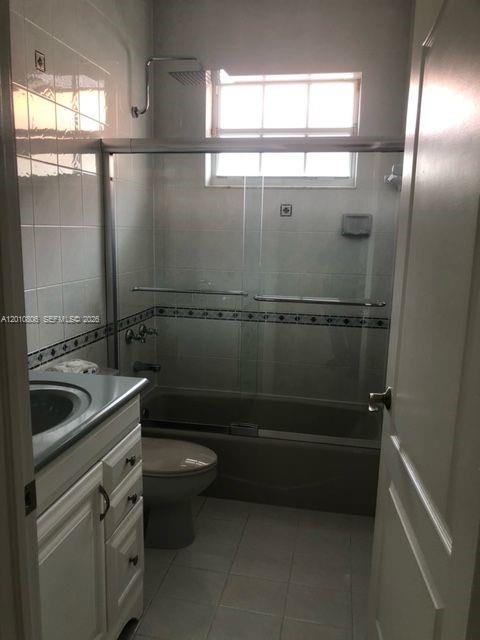 9910 Southwest 23rd Street Miami, FL 33165 - Photo 20 of 39 a bathroom with a sink a toilet a window and mirror