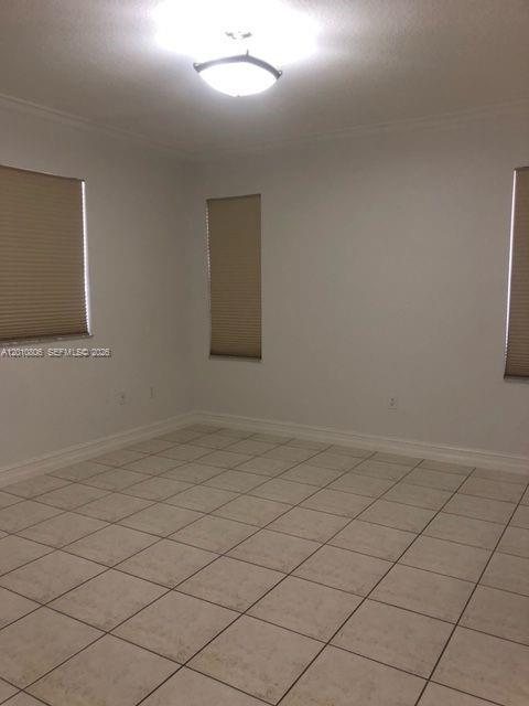 9910 Southwest 23rd Street Miami, FL 33165 - Photo 23 of 39 en empty room with windows