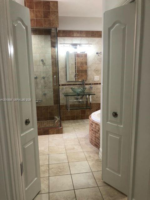 9910 Southwest 23rd Street Miami, FL 33165 - Photo 25 of 39 a bathroom with a glass door shower