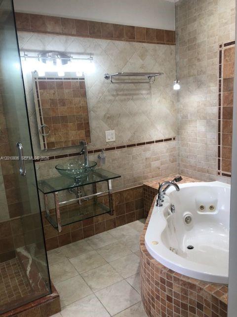 9910 Southwest 23rd Street Miami, FL 33165 - Photo 26 of 39 a bathroom with a tub and shower