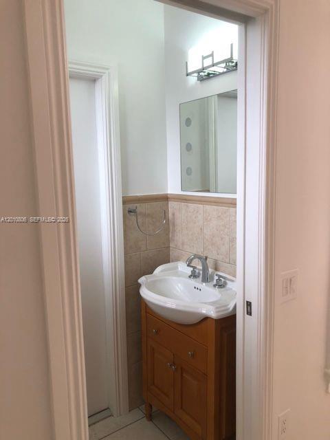9910 Southwest 23rd Street Miami, FL 33165 - Photo 30 of 39 a bathroom with a sink and a mirror