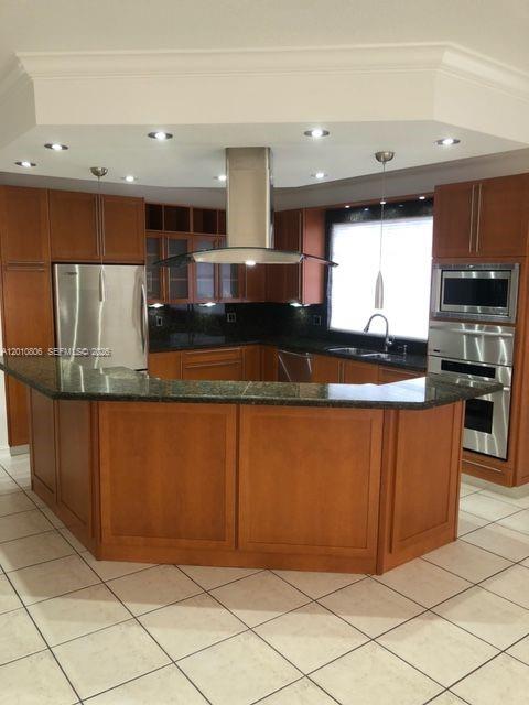 9910 Southwest 23rd Street Miami, FL 33165 - Photo 7 of 39 a kitchen with stainless steel appliances granite countertop a refrigerator and a stove