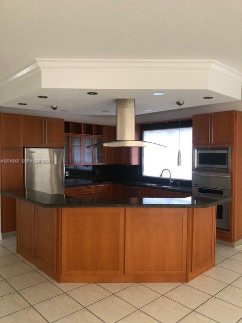 9910 Southwest 23rd Street Miami, FL 33165 - Photo 8 of 39 a kitchen with stainless steel appliances wooden cabinets and a counter top space