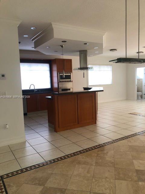 9910 Southwest 23rd Street Miami, FL 33165 - Photo 9 of 39 a kitchen with stainless steel appliances granite countertop a sink counter space cabinets and a window