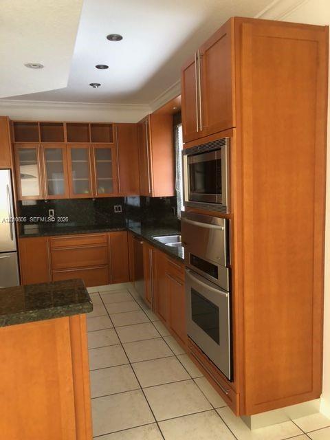 9910 Southwest 23rd Street Miami, FL 33165 - Photo 10 of 39 a kitchen with granite countertop a refrigerator and a sink