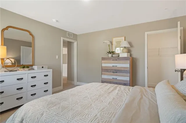 a bedroom with a bed and mirror