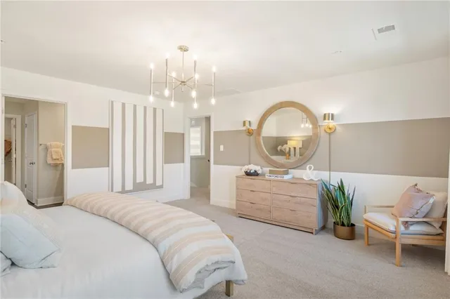 a bedroom with a bed a mirror and a large window