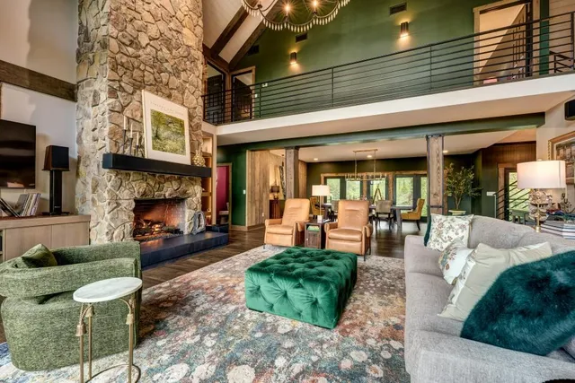 a dining hall with stainless steel appliances kitchen island granite countertop a table chairs and a glass door