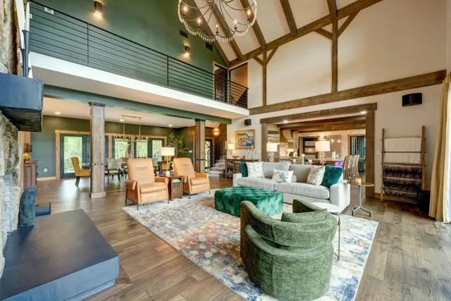 a view of a kitchen with stainless steel appliances granite countertop a lot of counter space cabinets and a couch