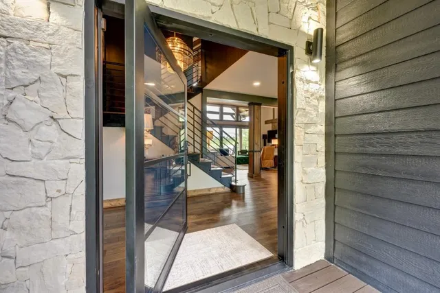 a view of a room with wooden floor and potted plant