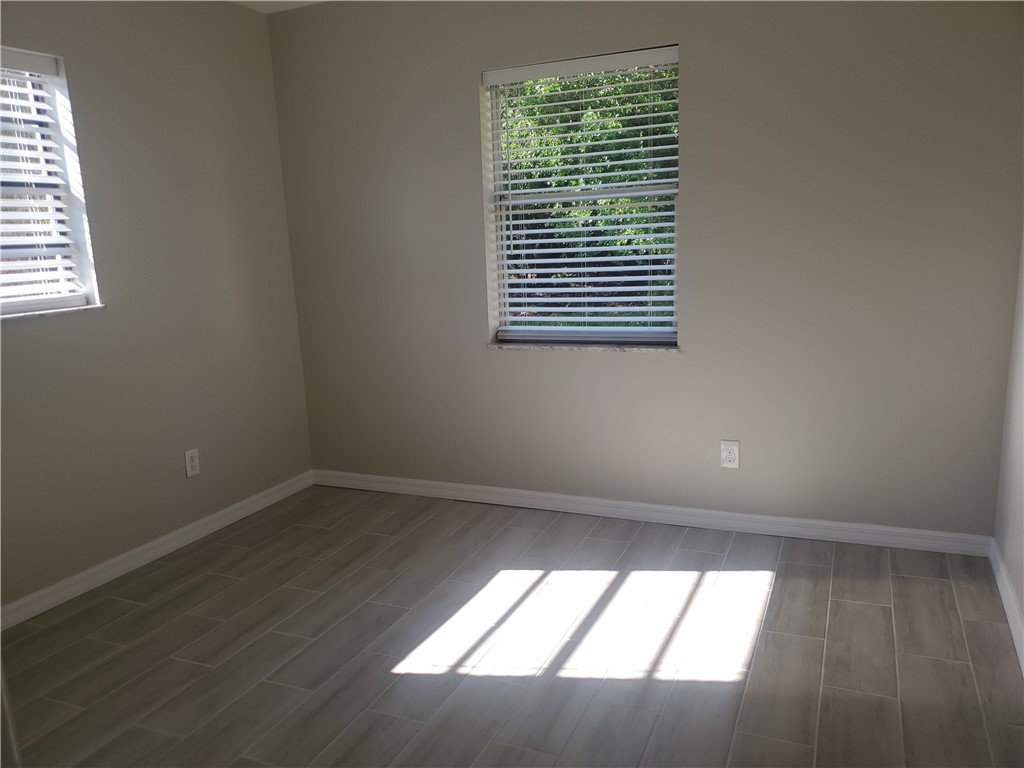 3300 South 7th Street, Unit B Fort Pierce, FL 34982 - Photo 17 of 32 an empty room with a window