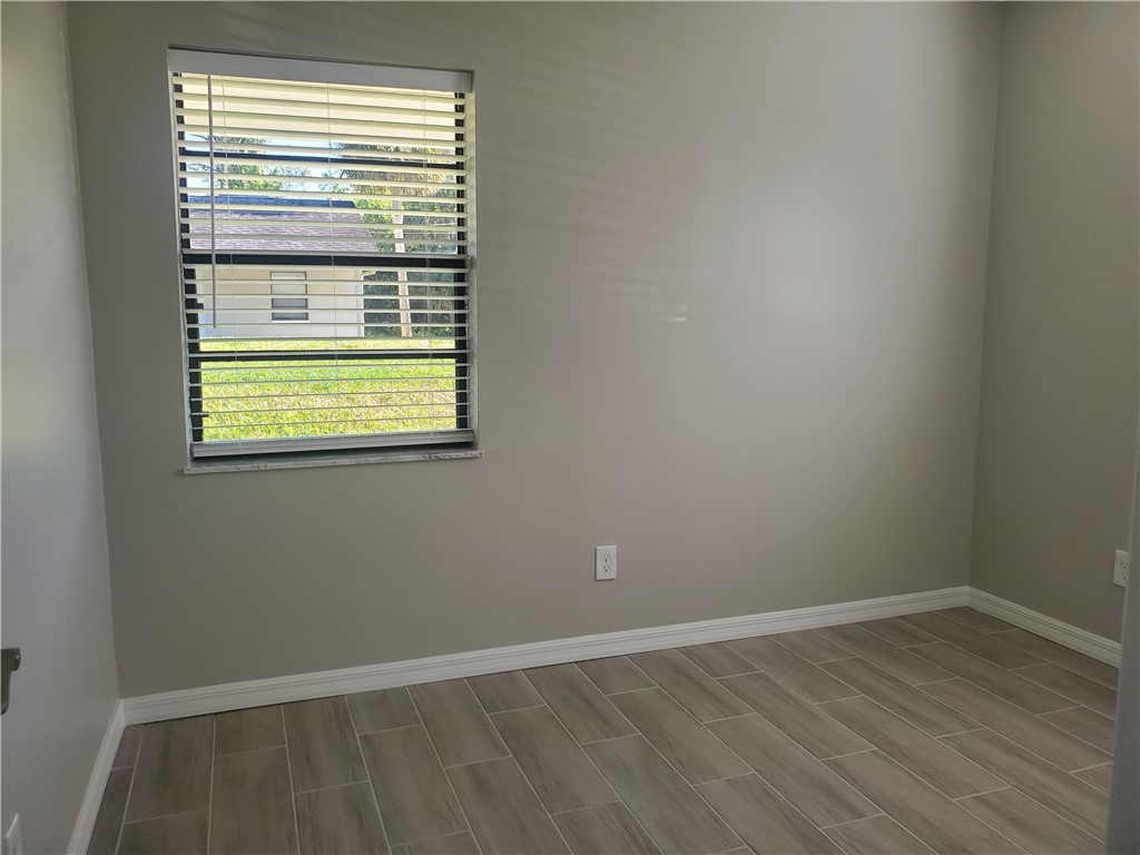 3300 South 7th Street, Unit B Fort Pierce, FL 34982 - Photo 20 of 32 an empty room with a window
