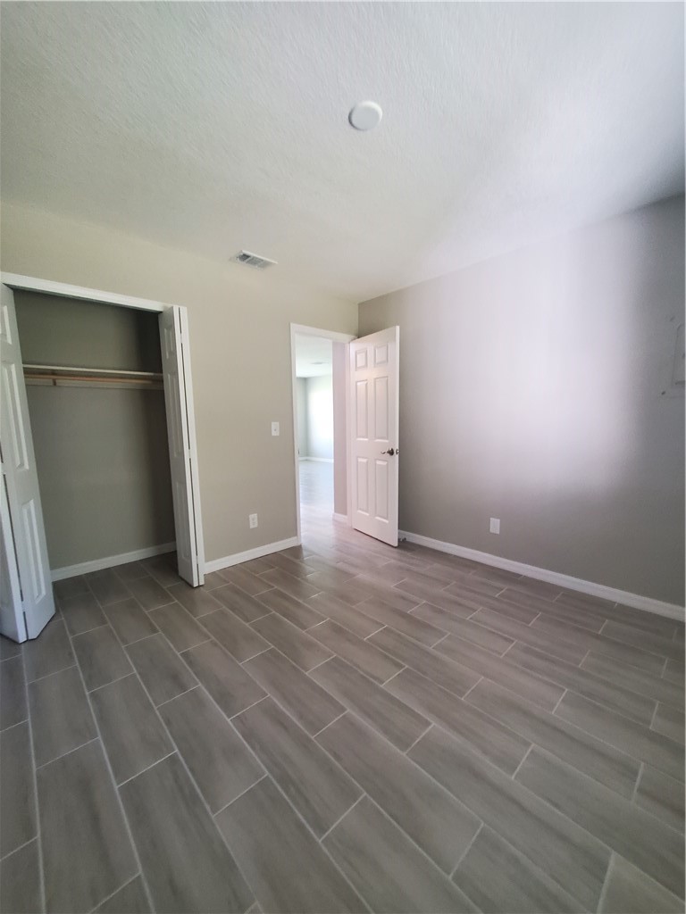 3300 South 7th Street, Unit B Fort Pierce, FL 34982 - Photo 26 of 32 a view of an empty room with closet and a window