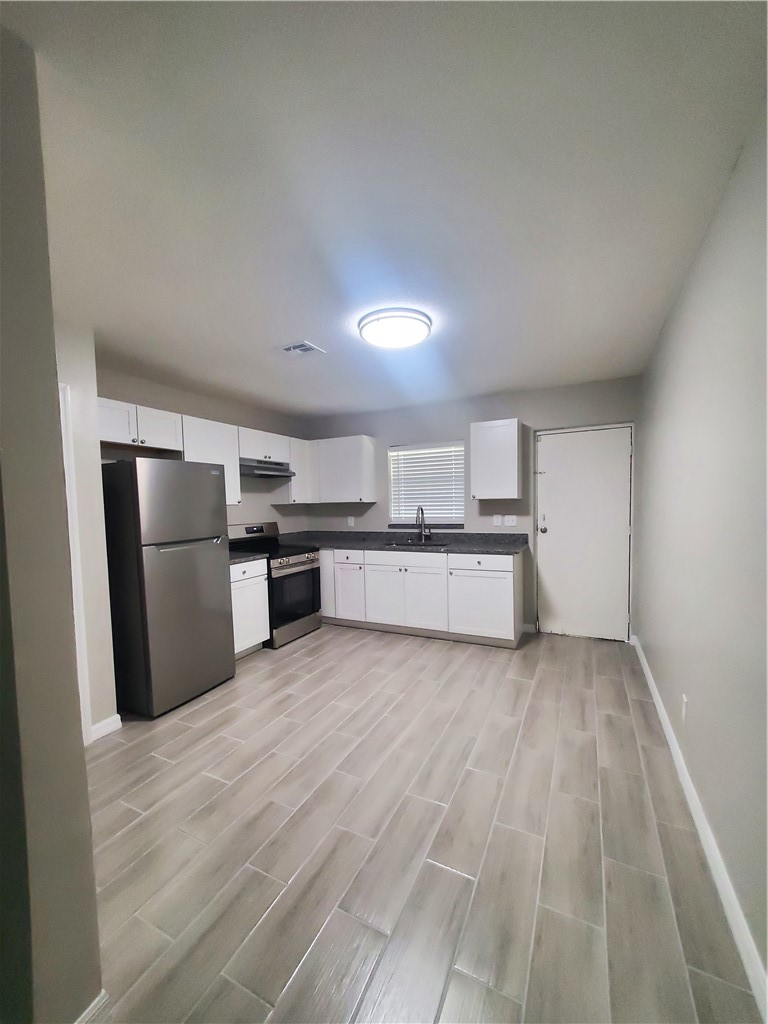 3300 South 7th Street, Unit B Fort Pierce, FL 34982 - Photo 5 of 32 a view of kitchen with wooden floor
