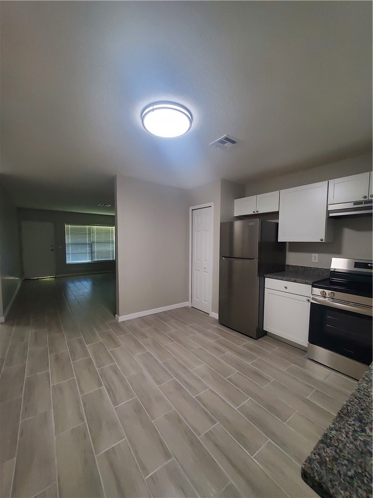 3300 South 7th Street, Unit B Fort Pierce, FL 34982 - Photo 8 of 32 a kitchen with stainless steel appliances a refrigerator and a stove top oven