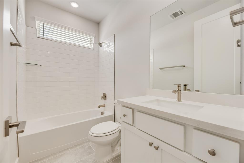 920 Ash Road Plano, TX 75075 - Photo 23 of 27 a bathroom with a sink a toilet and shower