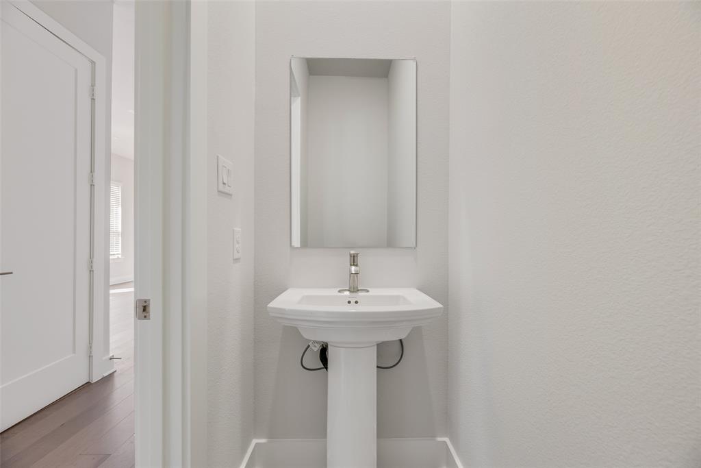 920 Ash Road Plano, TX 75075 - Photo 25 of 27 a bathroom with a sink and a mirror
