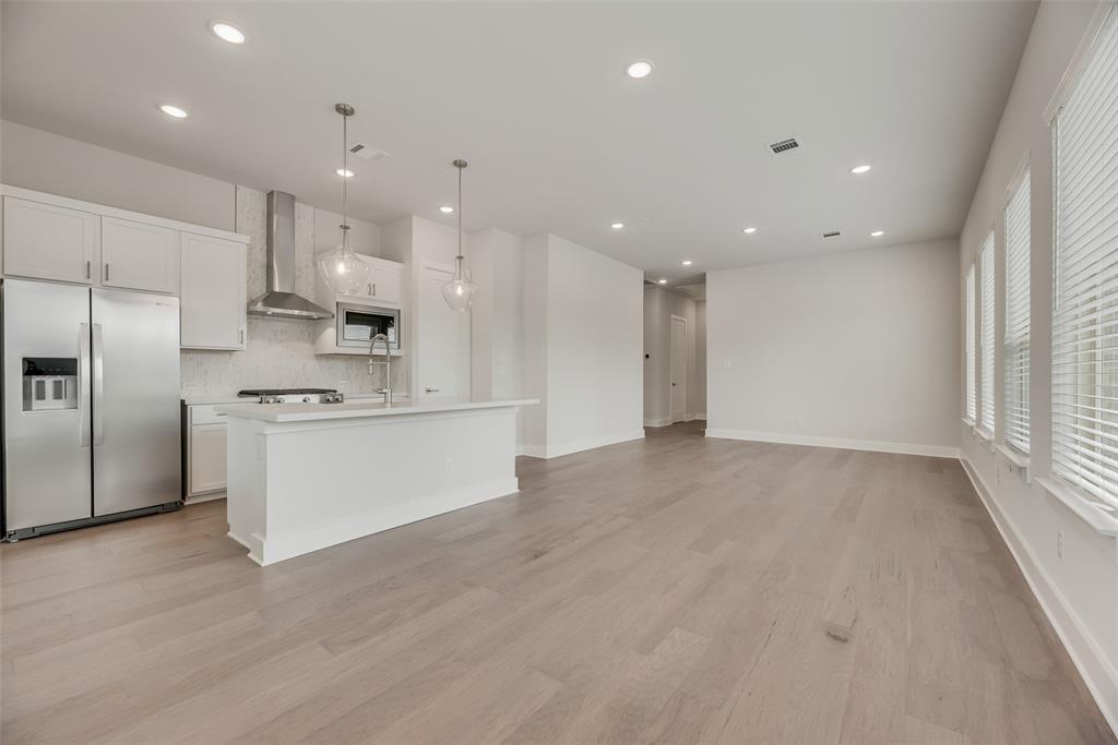 920 Ash Road Plano, TX 75075 - Photo 7 of 27 a view of kitchen with kitchen island a sink stainless steel appliances and cabinets
