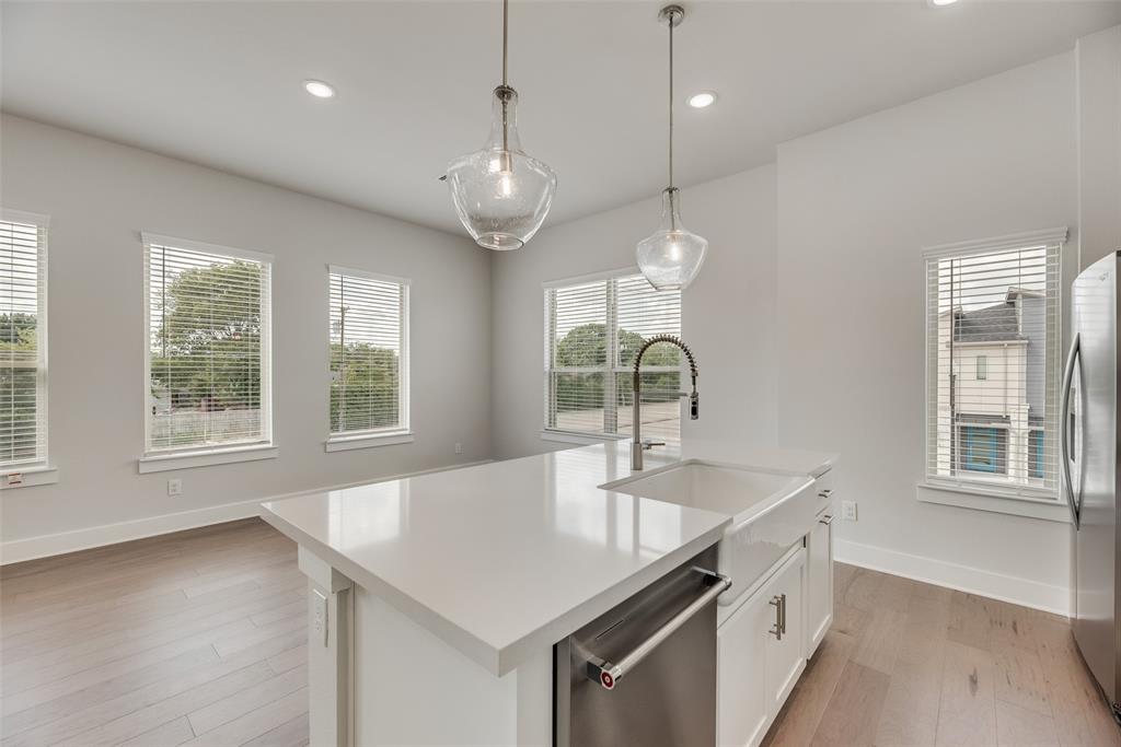 920 Ash Road Plano, TX 75075 - Photo 9 of 27 a kitchen with stainless steel appliances granite countertop a sink a window and a kitchen island