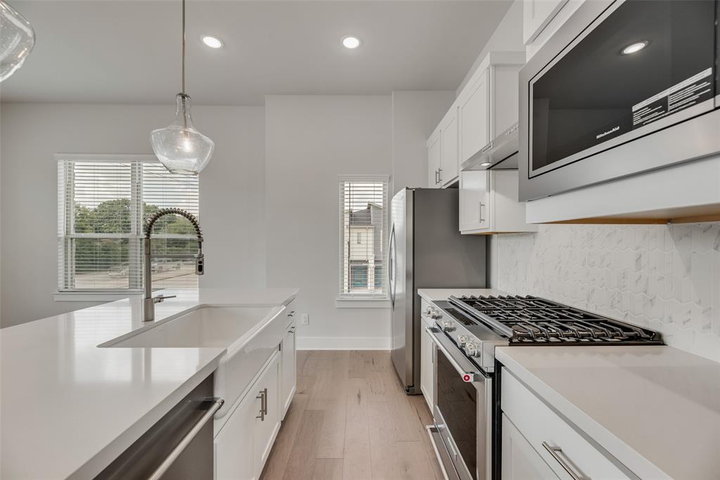 920 Ash Road Plano, TX 75075 - Photo 10 of 27 a kitchen that has a sink and a stove