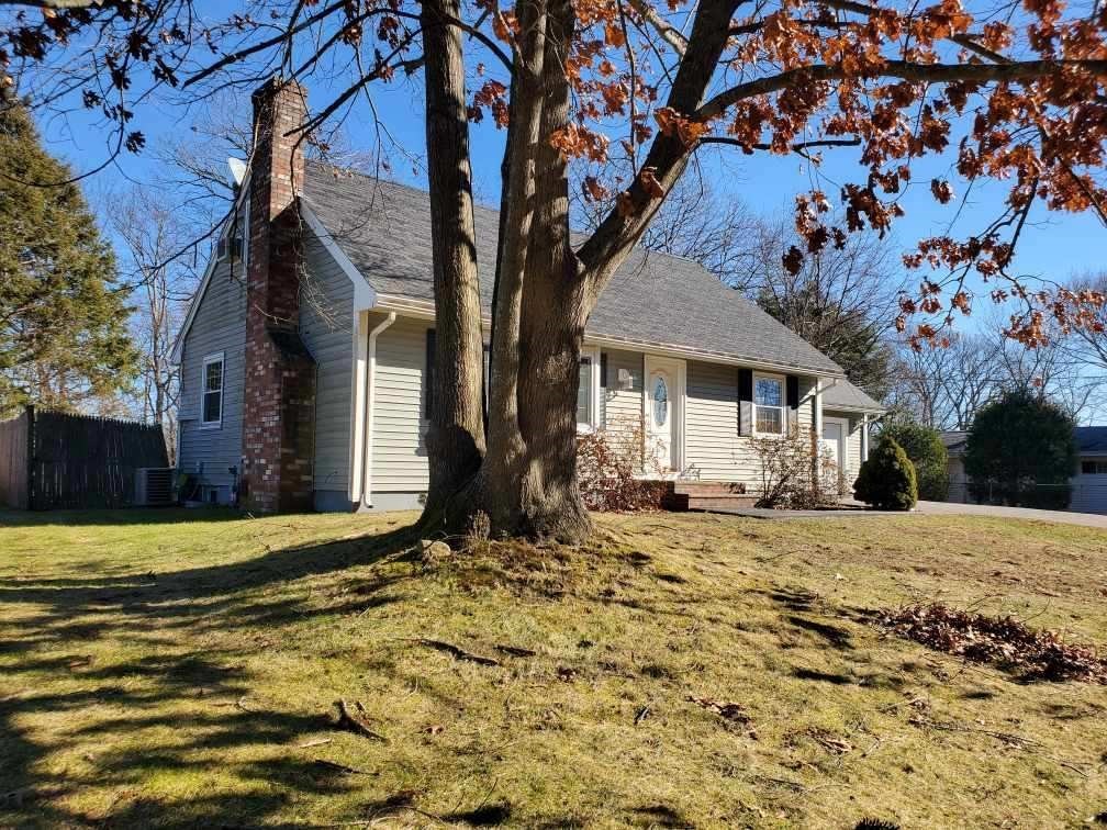 27 Upton Street Brockton, MA 02302 - Photo 3 of 24 a front view of a house with a yard