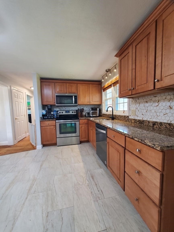 27 Upton Street Brockton, MA 02302 - Photo 6 of 24 a large kitchen with stainless steel appliances granite countertop a stove top oven a sink dishwasher and a microwave oven on the blue kitchen countertops