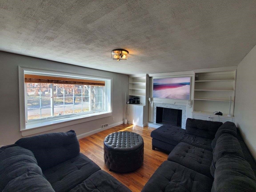 27 Upton Street Brockton, MA 02302 - Photo 10 of 24 a living room with furniture and a fireplace