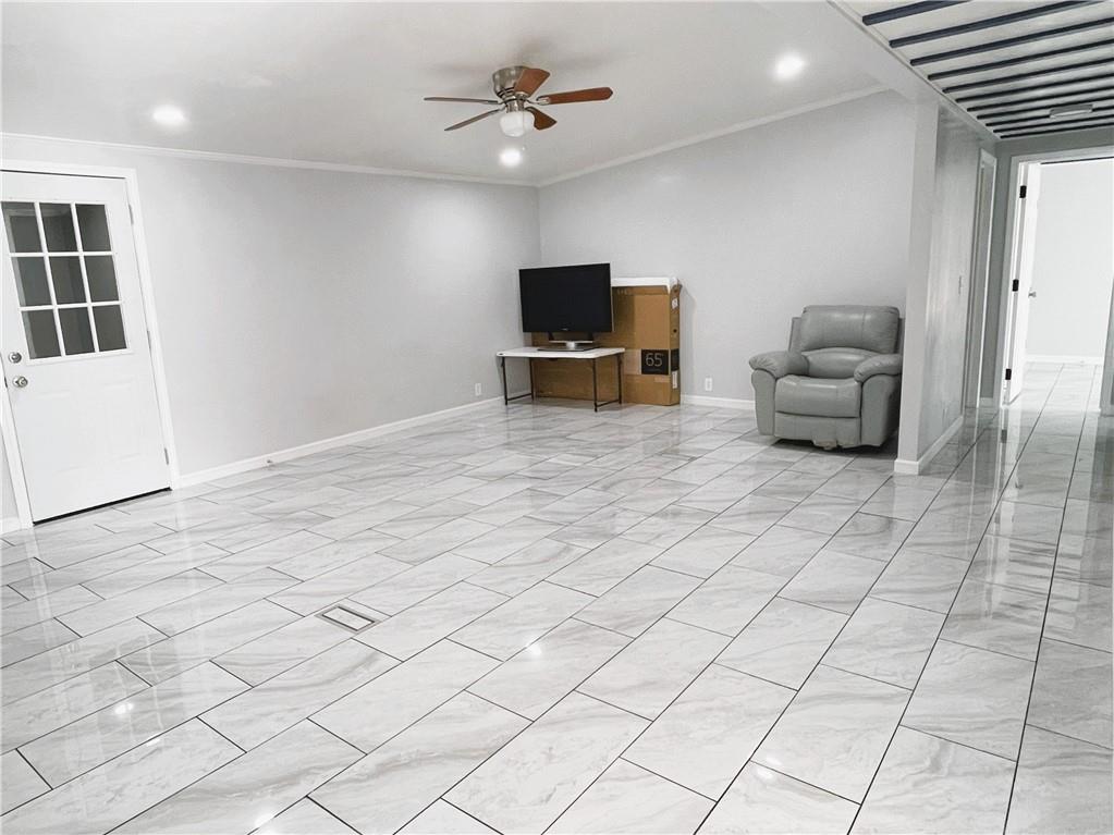 6225 Lollis Creek Road Flowery Branch, GA 30542 - Photo 12 of 36 a living room with furniture and a flat screen tv
