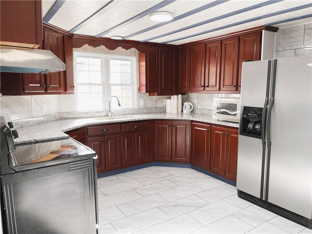 6225 Lollis Creek Road Flowery Branch, GA 30542 - Photo 13 of 36 a kitchen with a sink appliances and cabinets