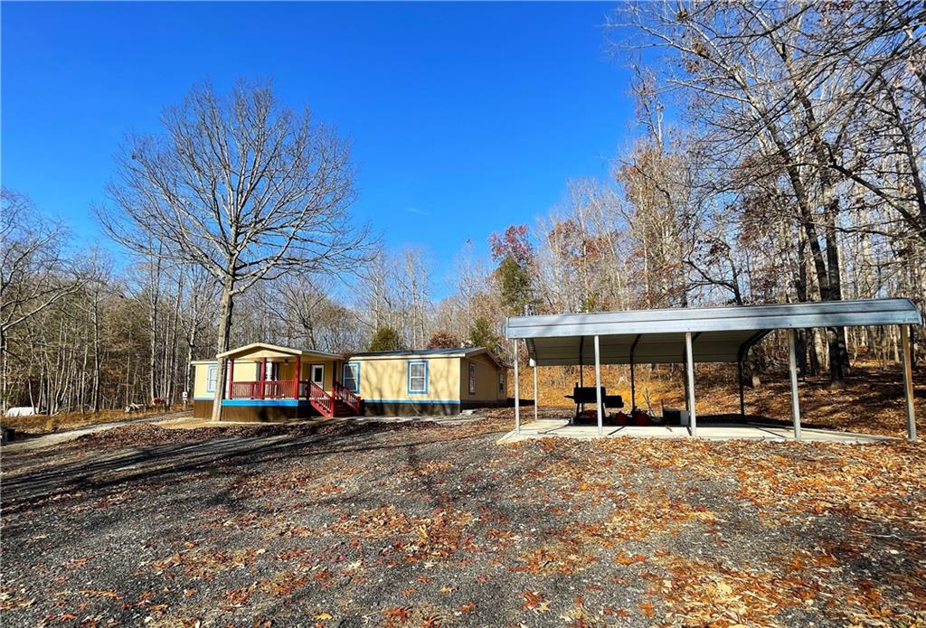 6225 Lollis Creek Road Flowery Branch, GA 30542 - Photo 4 of 36 a view of road with card parked on side and road