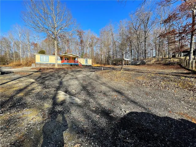 a view of large house with a yard and covered with snow