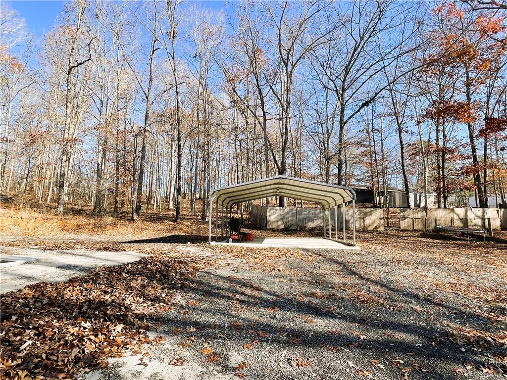 6225 Lollis Creek Road Flowery Branch, GA 30542 - Photo 6 of 36 a view of large house with a yard and covered with snow