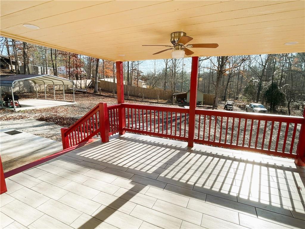 6225 Lollis Creek Road Flowery Branch, GA 30542 - Photo 7 of 36 a view of a balcony with wooden floor and outdoor space