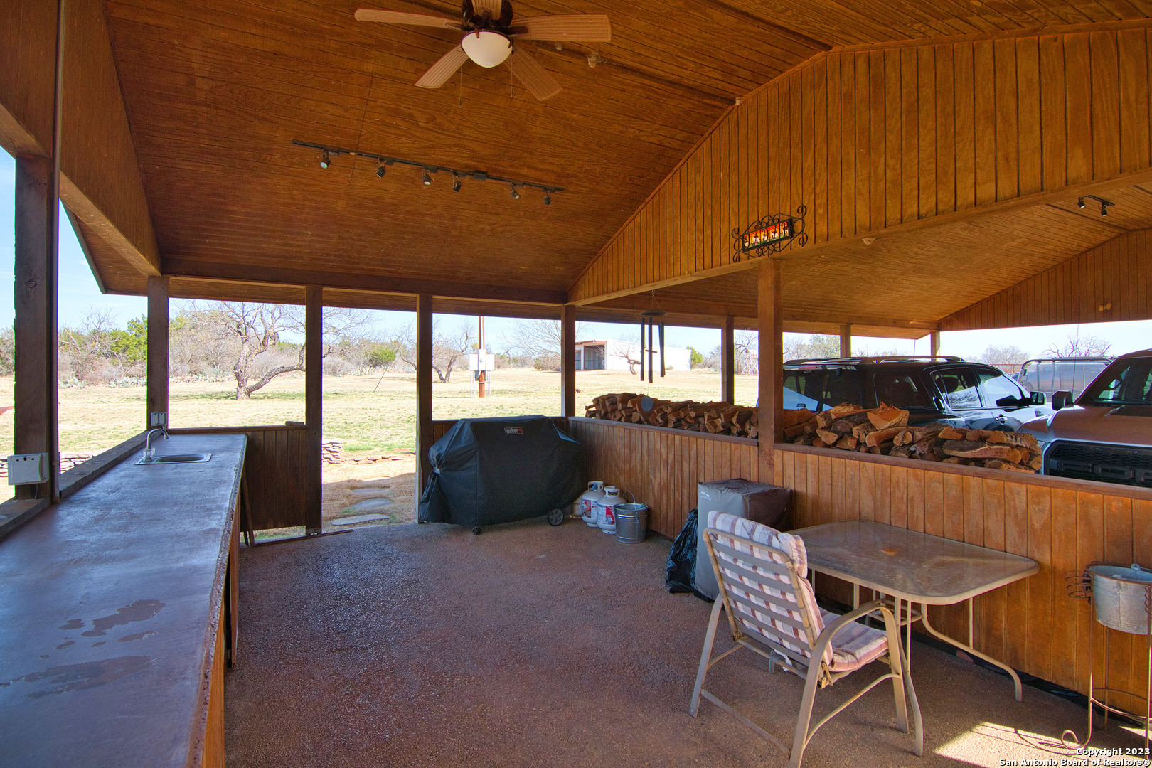 19316 Ranch Road 1871 Mason, TX 76856 - Photo 15 of 37 a view of a patio with a table and chairs under an umbrella