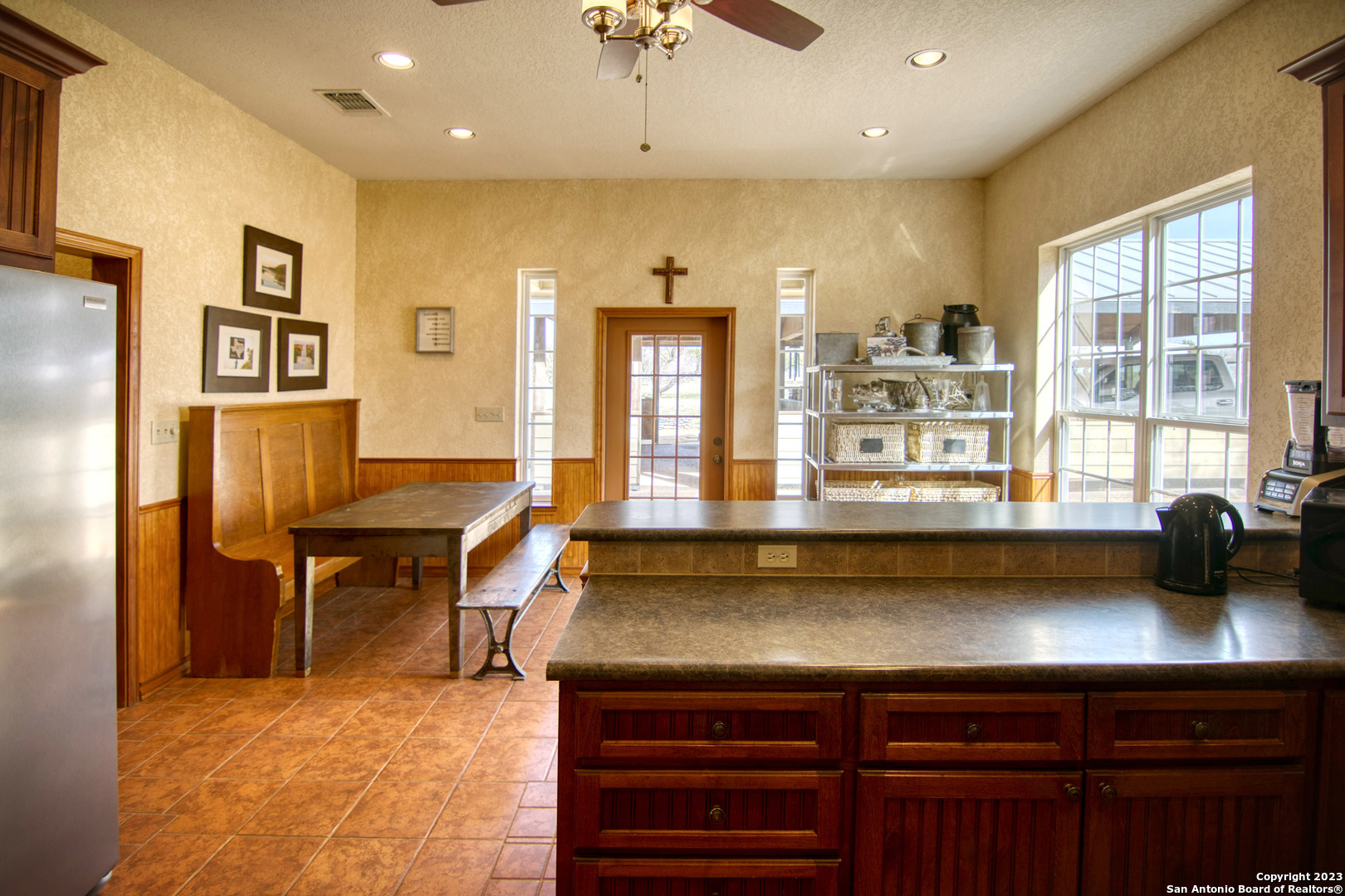 19316 Ranch Road 1871 Mason, TX 76856 - Photo 25 of 37 a kitchen with a table chairs refrigerator and cabinets