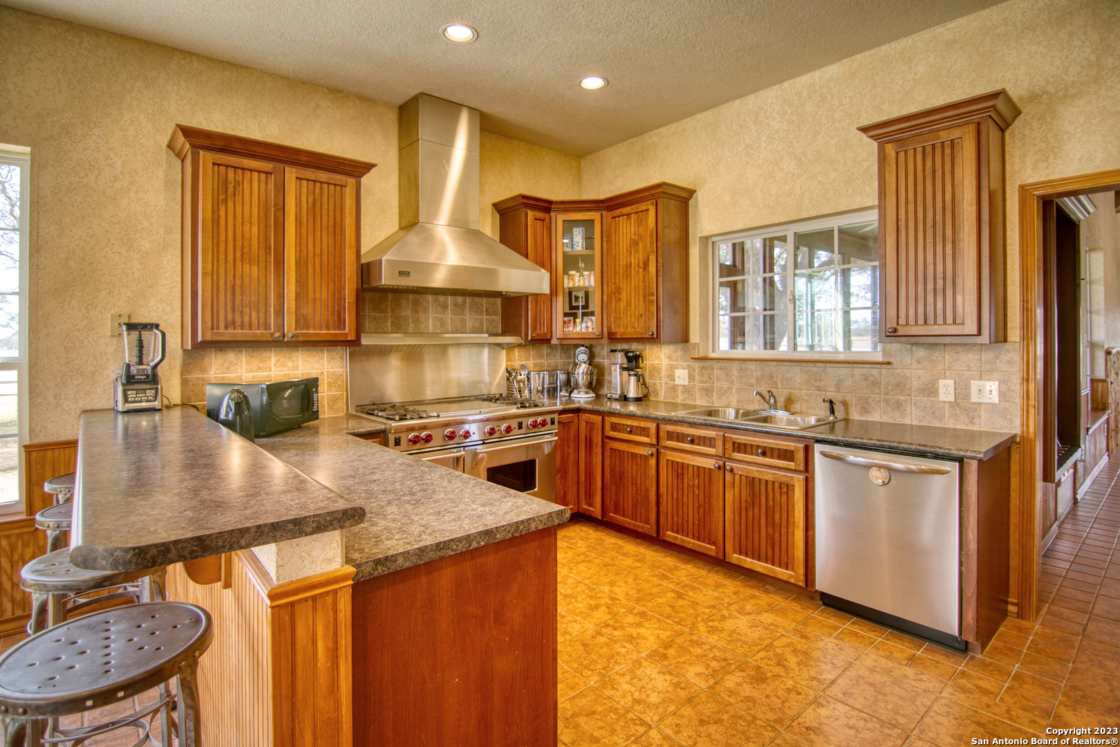 19316 Ranch Road 1871 Mason, TX 76856 - Photo 26 of 37 a kitchen with stainless steel appliances granite countertop a sink stove and refrigerator