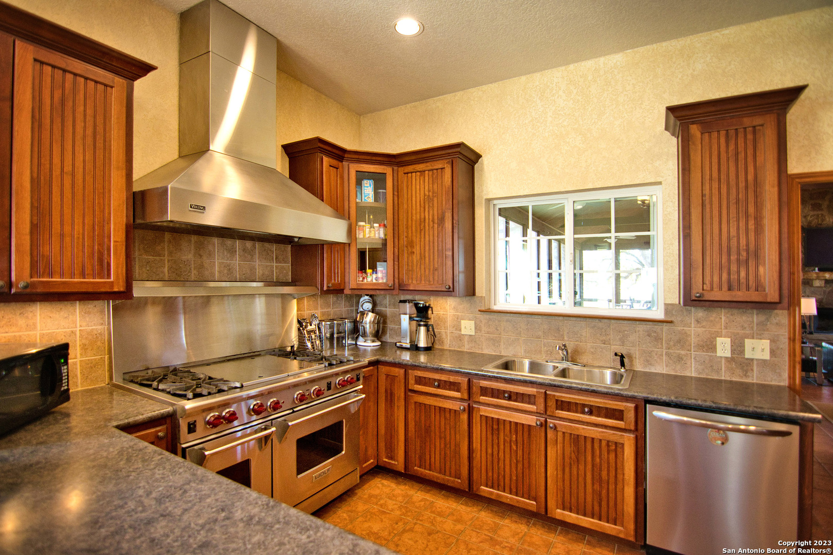 19316 Ranch Road 1871 Mason, TX 76856 - Photo 28 of 37 a kitchen with stainless steel appliances granite countertop a stove a sink and a microwave