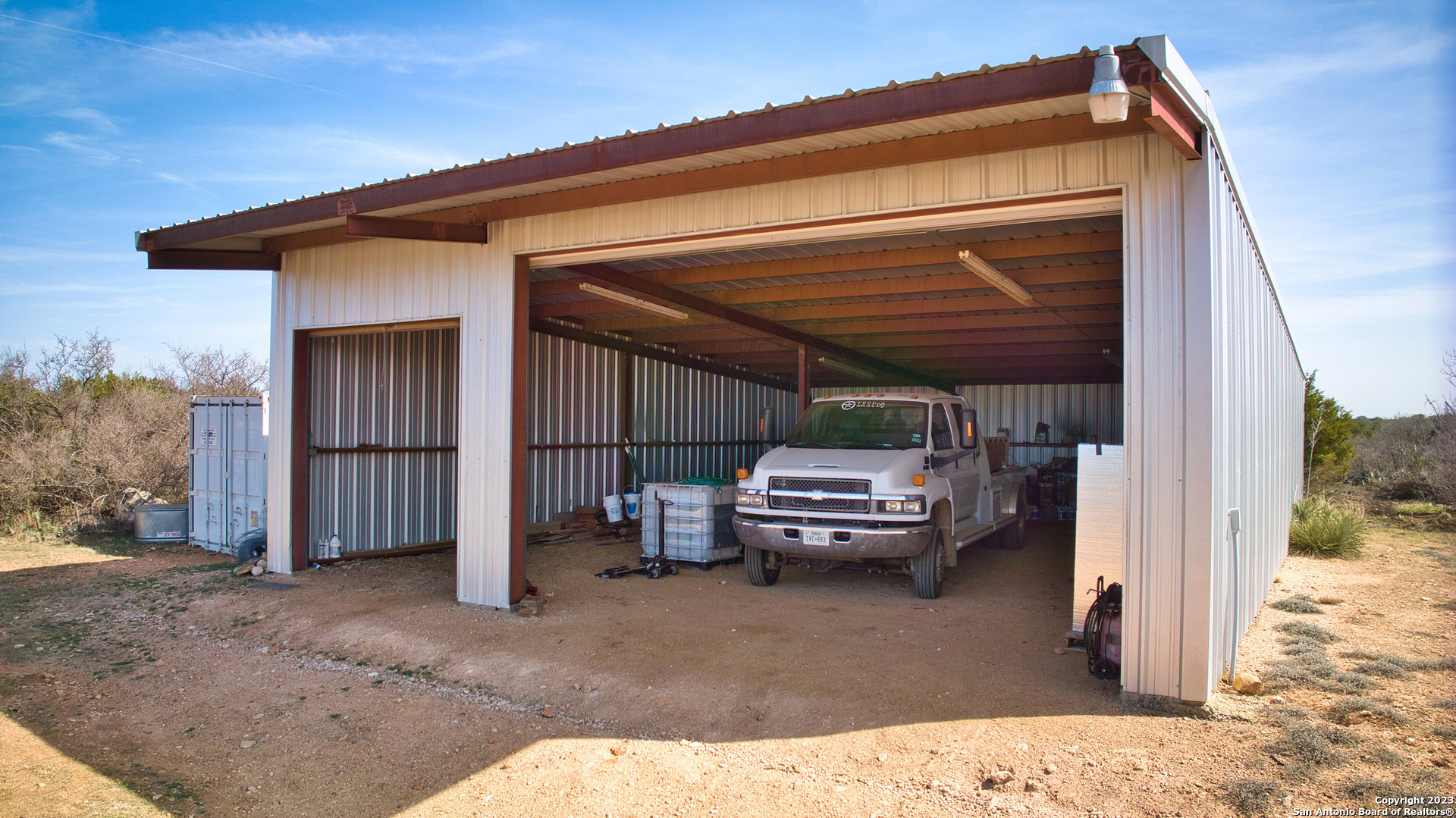 19316 Ranch Road 1871 Mason, TX 76856 - Photo 6 of 37 a view of a house with a barbeque and wooden roof