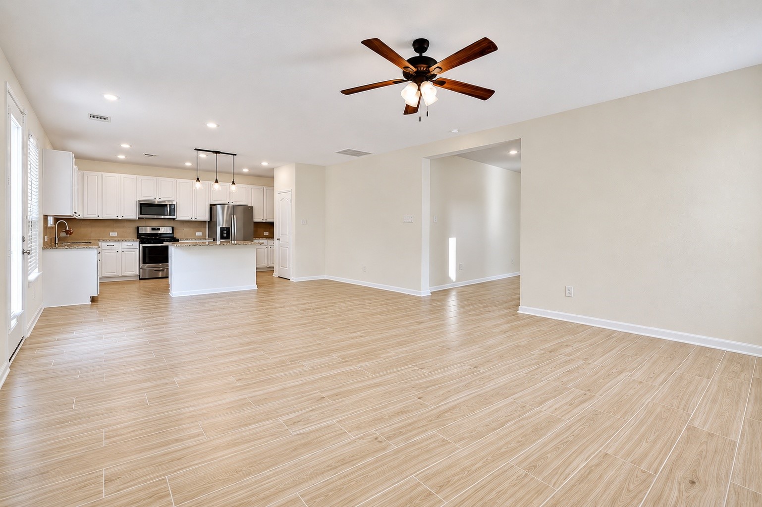 2107 Parnevik Place Conroe, TX 77304 - Photo 10 of 44 And there is plenty of space for a formal dining table this side of the kitchen's island/breakfast bar