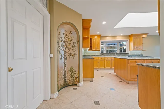 a large kitchen with stainless steel appliances granite countertop a stove and large sink