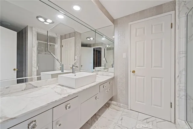 a spacious bedroom with a bed and glass windows