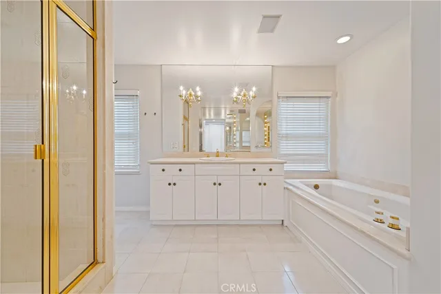 a bedroom with a bed and large windows