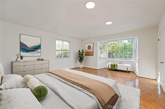 a spacious bathroom with a granite countertop sink a mirror and shower